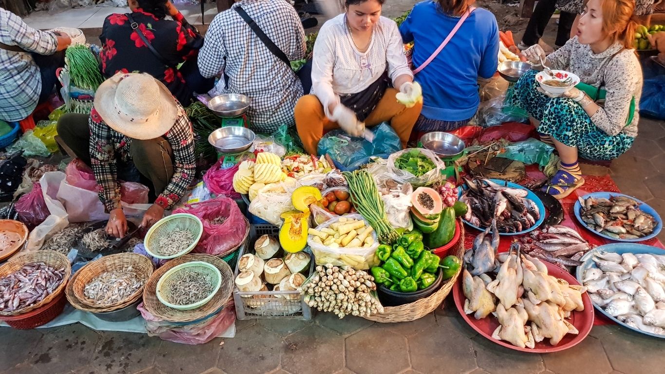 Explore the authentic rhythm of Cambodia in its lively local markets at sunrise