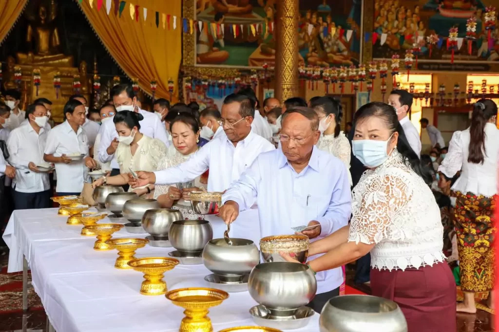 Locals gather at a pagoda during Pchum Ben to offer food, incense, and prayers for their ancestors